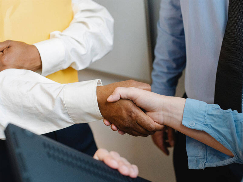 Picture of business men and women shaking hands