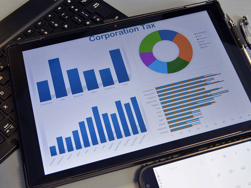 Tablet computer showing charts with the title of corporation tax