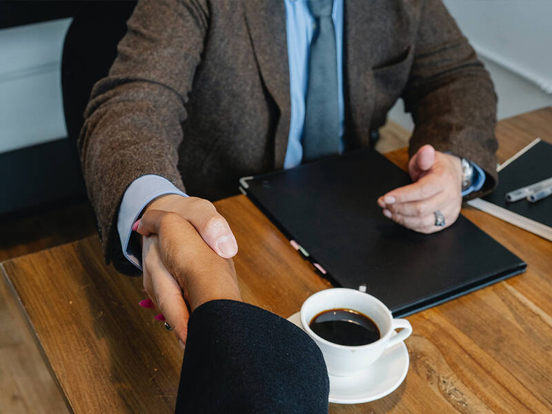 Business people shaking hands to conclude a successful meeting