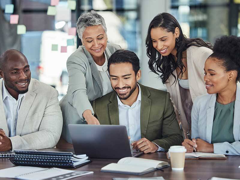Business men and women looking at the screen of laptop computer