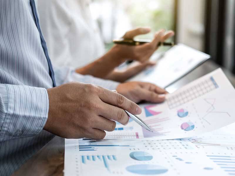 Business man looking at charts and figures on paper