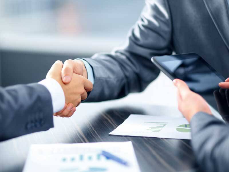 Business men and women shaking hands
