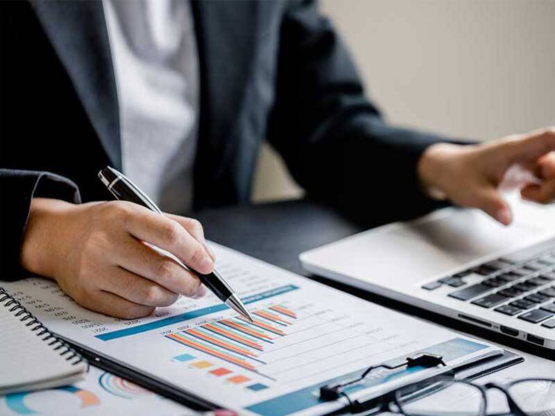 Business men reviewing charts and information