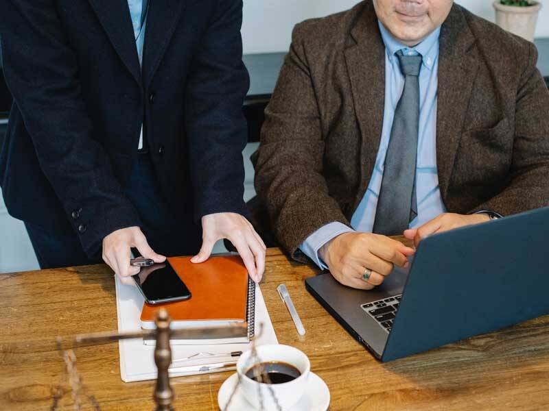 Business man and woman looking at the screen of a latop computer