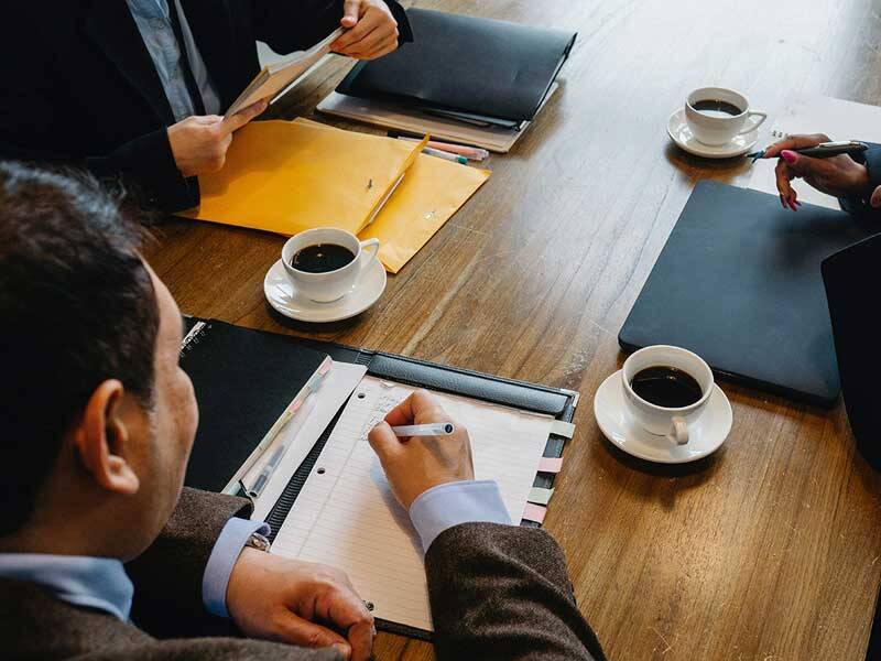 Business men and woman sitting around a conference table