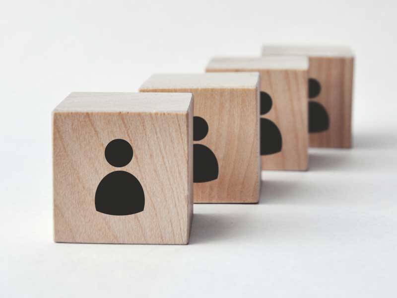 Wooden building blocks with illustrative silhouettes for personnel