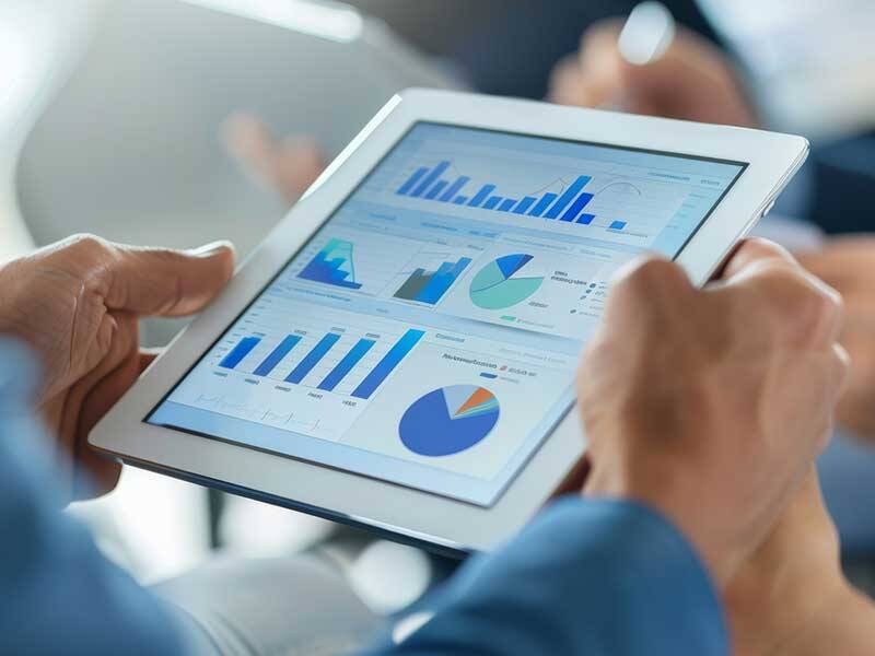 Business man looking at charts and figures on the screen of tablet computer