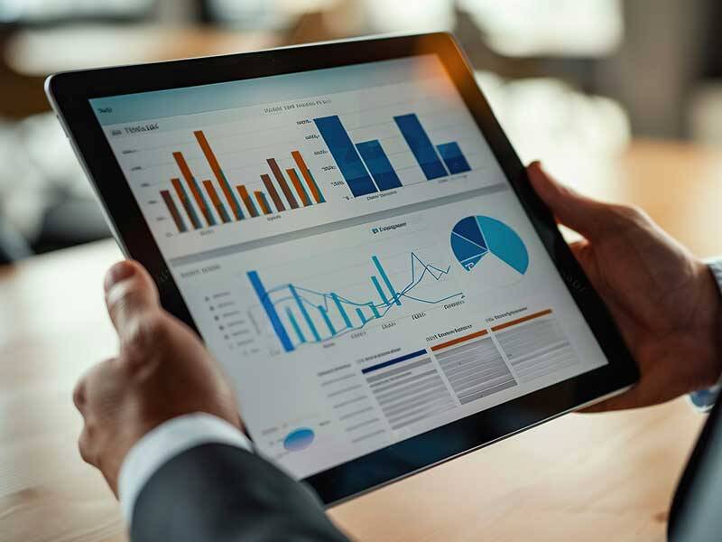 Business man looking at charts and information on a tablet computer screen